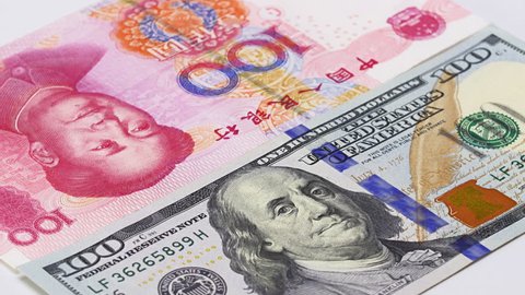 Yuan vs Dollar bank notes rotating concept business background, loop ready