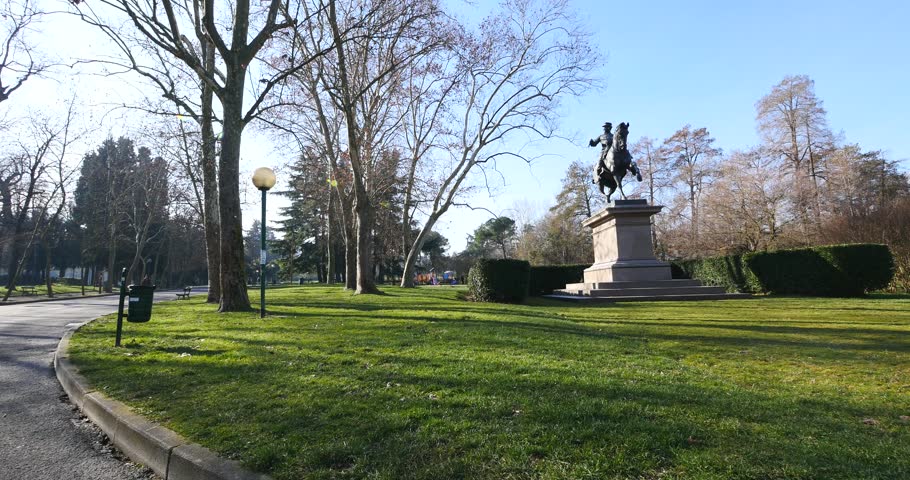 Regina Margherita Park in a sunny day with Vittorio Emanuele II statue. Bologna, Italy.