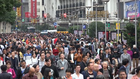 SHANGHAI, CHINA - 31 OCTOBER 2015: Locals and tourists (both domestic and foreign) walk through the busy Nanjing Road shopping street in Shanghai, China