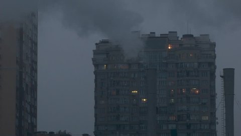 of the Pipe is White Thick Smoke, Amid the High-Rise Building With Residential Apartments, is a Light in the Windows, the Smoke Goes Into the Windows of People, Ecological Disaster of the Big City