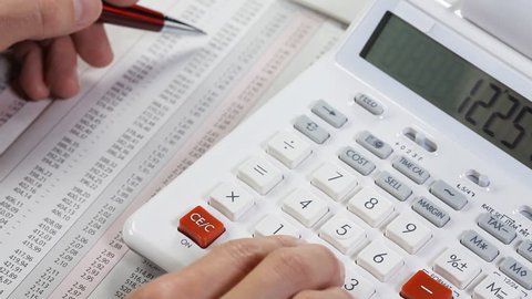 Accounting. Business woman working with a calculator and documents.  