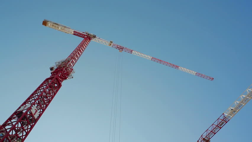 3 huge construction site cranes move supplies, skyscraper building, Tel-Aviv