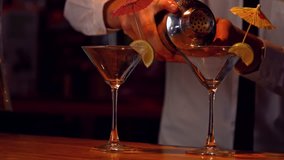 Bartender pouring cocktails on counter in high quality 4k format - Powered by Shutterstock - Get 15% off with code: PIKWIZARD15