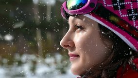 Beautiful woman prepares for skiing ; Women skier prepares for skiing and set up on the head of ski goggles,slow motion video clip