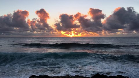 Sunrise and waves crashing on a black sand beach (4K)