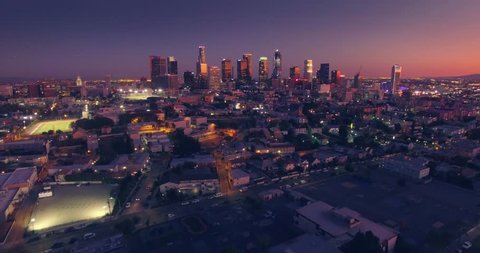 Scenic aerial view of city of downtown Los Angeles skyline at sunset twilight dusk night. 4K UHD.