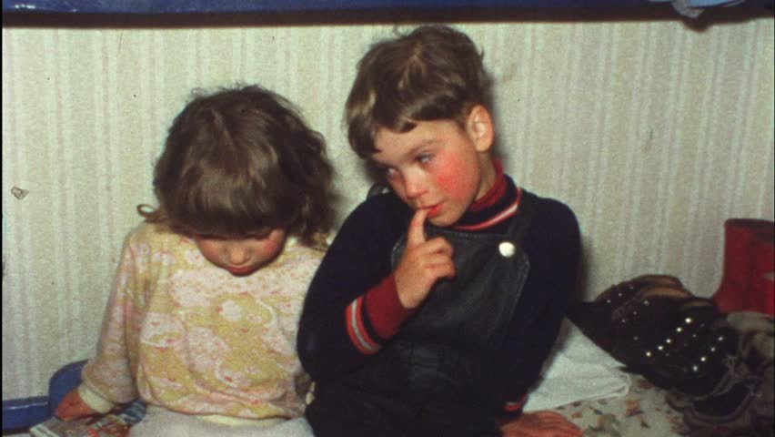 Sad boy wants sister to comfort him (Vintage 8 mm amateur film) | Shutterstock HD Video #1493401