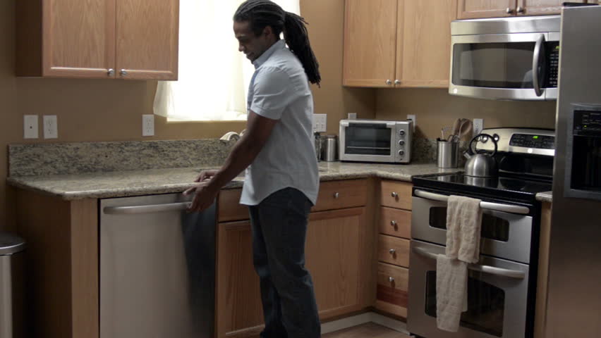 A Modern African American Family completes tasks around the house from paying