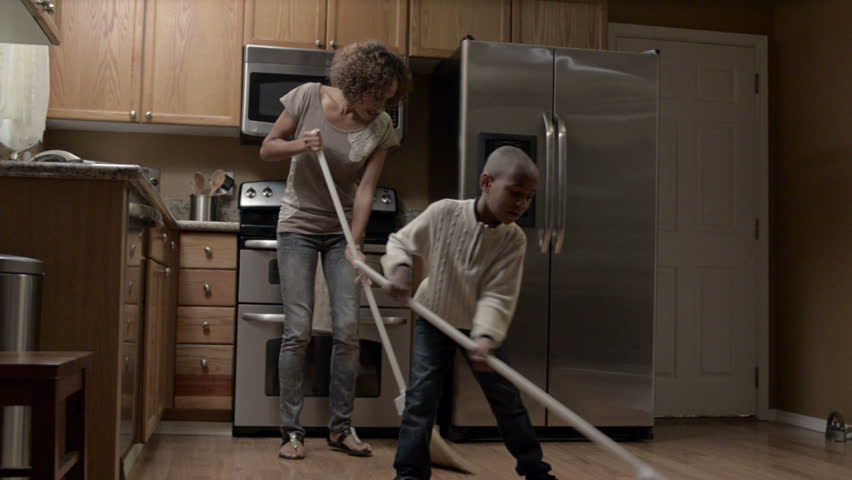 A Modern African American Family completes tasks around the house from paying