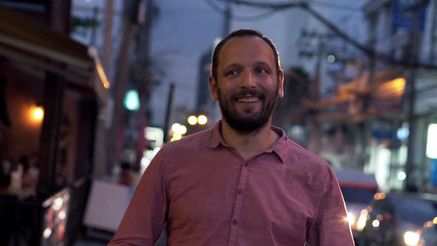 Portrait of happy, young guy in the city in the evening 
 | Shutterstock HD Video #14959486