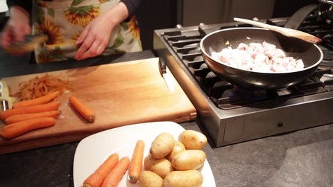 Stew meat preparation with potatoes and carrots, cut and flouring
