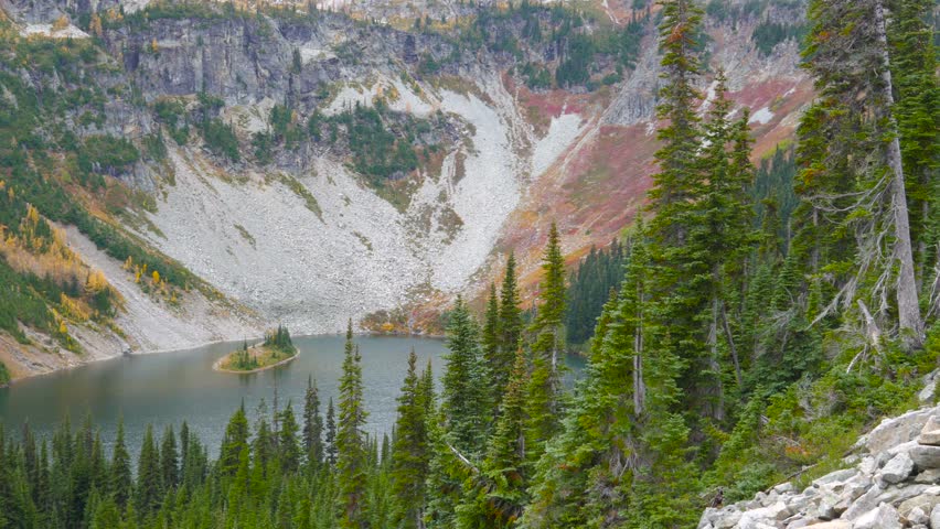 A small lake amidst the scenic autumn mountains shrouded in mist, A forest lake high in the mountains. North Cascades National Park. Washington state. Landscape video.4K, 3840*2160, high bit rate, UHD