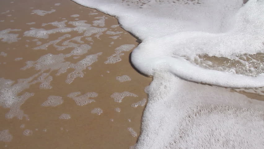 Close-up of the surf on a beach.