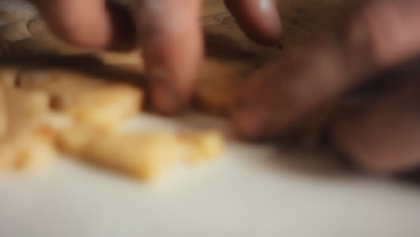 Close-Up Shot of Male Hands Using Metal Cutout to Make a Heart Shape Cookie From the Dough on White Table, Cutting Out Heart Shaped Cookies Form Dough. the Process of Baking Cookies at Home
