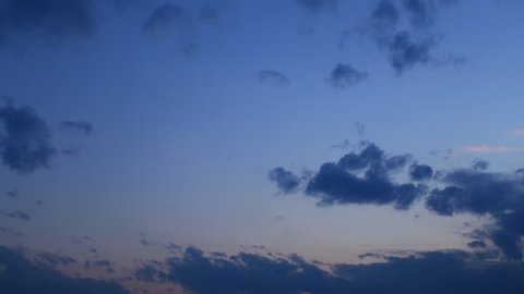 Timelapse of grey, black,  blue  clouds, moving clouds,on blue sky  background, day becomes night