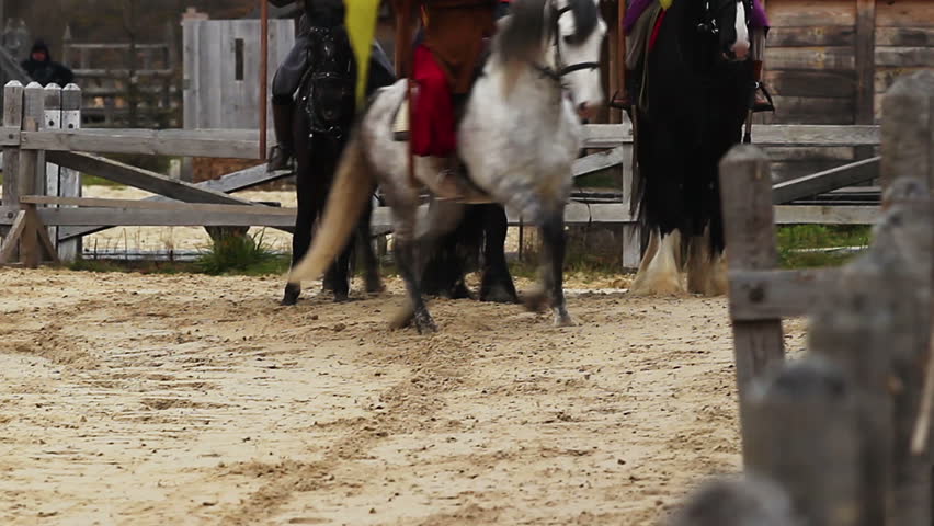 Horse riders with flags. Horses running at gallop. Medieval action with knights