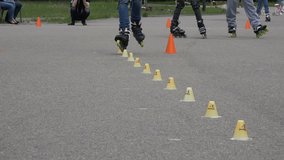 unidentified sportsman with roller skate ride style slalom element with cone in stadium. video clip. Roller skater sport day.