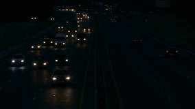 Ungraded: Highway at Night / Highway Road / Highway Traffic. Cars driving on a six-lane highway with head-lights turned on. Source: Lumix DMC, ungraded H.264 from camera. (av25763u)