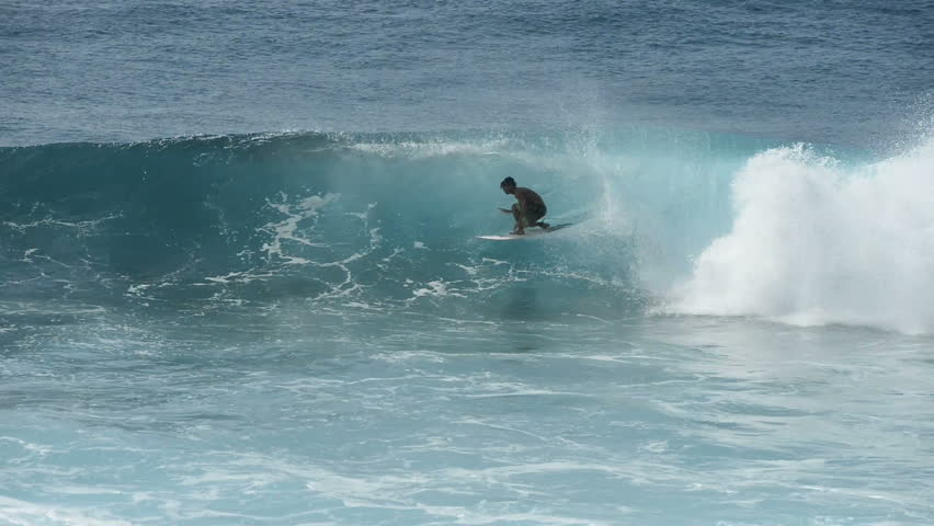 Maui, Hawaii, USA - February 26, 2016: A skillful surfer riding through inside of a big breaking tidal wave in Honolua Bay at north-west coast of West Maui. | Shutterstock HD Video #15011140