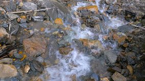 Mountain creek among large boulders in the autumn. Nature video. 4K, 3840*2160, high bit rate, UHD