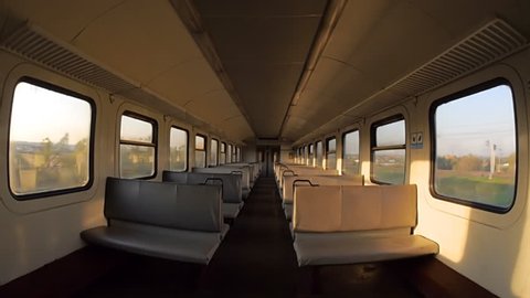 The train is moving rapidly to a destination. View inside the empty railway carriage. Wide angle lens