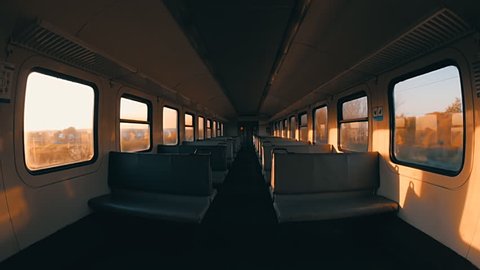 In the windows of the train wagon is glimpse the train passing opposite. View inside the empty railway carriage. Wide angle lens