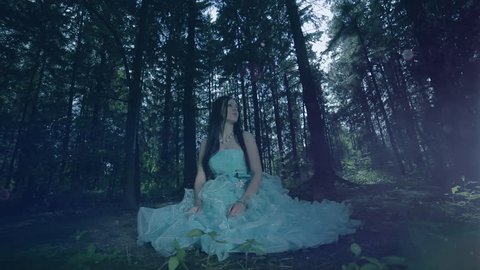 Fairy tale. The charming girl sitting in the fairy forest. (slow motion)