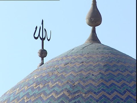 Baghdad, Iraq - 2002 - Close up of the cupola or dome of the Mustansiriya Madrasah mosque showing the blue tile work and a spike with the word God written in Arabic 'Allah'.