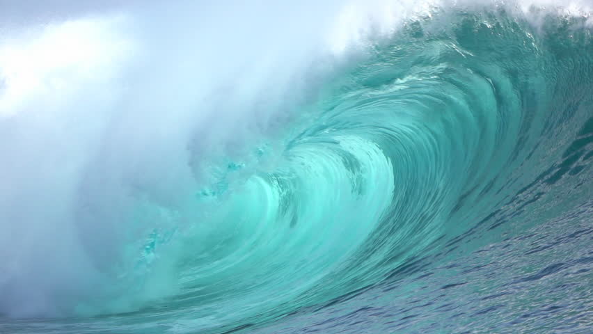 SLOW MOTION CLOSE UP: Big powerful Teahupoo tube wave breaking and splashing over the island reef, water drops spraying in the wind in sunny summer