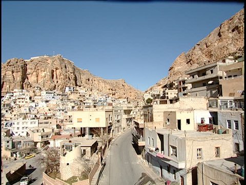Maaloula, Syria - 2005 - Pan left across Maaloula showing houses, churches and monasteries and ending on a church bell tower.