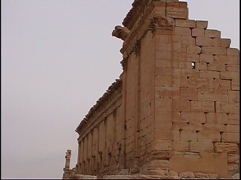 PALMYRA, SYRIA - CIRCA 2005: Pan right across the ruins of the temple of Bel in the ancient city of Palmyra in Syria. The temple was destroyed by ISIS in 2015. Palmyra is a UNESCO World Heritage Site.