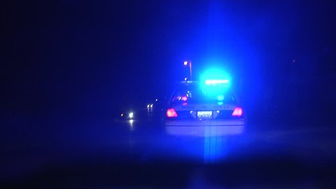 Police speeding to a scene at night