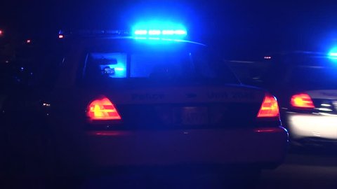 Police arrive at a scene at night POV