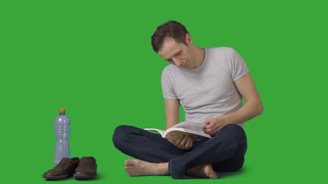 Attractive barefooted man squats crosslegged and reads book. Front view. Footage with alpha channel. File format - mov. Codec - PNG+Alpha Combine these footage with other people to make crowd effect