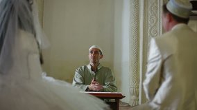 Imam (islamic priest) preaching at the Wedding Ceremony Nikah of Crimean Tatars in Mosque. Bakhchisaray Palace (Hansaray, Khan's Palace) Bakhchisaray, Crimea, Ukraine