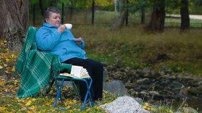 senior woman drinking coffee,  Side View
