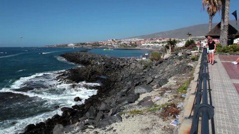 COSTA ADEJE, TENERIFE, CANARY, SPAIN-CIRCA JAN, 2016: Spectacular view at the Atlantic ocean and cliffs opens for visitors. Pedestrian path near the Playa Torviscas and Playa Fanabe resorts