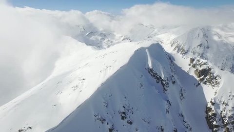 Beautiful Mountain Range Winter Landscape Clouds Aerial Flight Footage Over Peaks Epic Panorama  UHD 4K