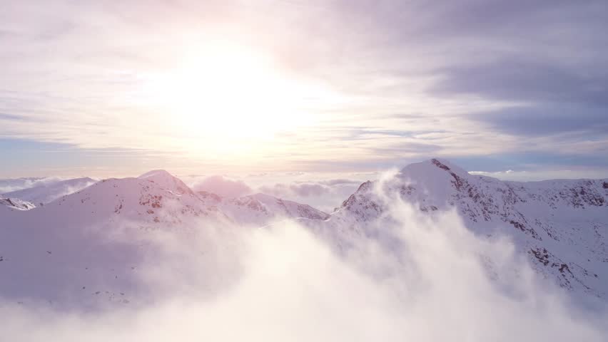 Epic Aerial Flight Through Mountain Clouds Towards Sunrise Beautiful Morning Peaks Inspirational Motivational Nature Background UHD 4K