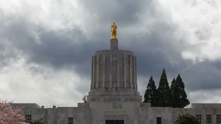 Ultra High Definition 4k Time lapse movie of dramatic moving clouds and sky over closeup on Salem State Capitol in Oregon during spring season 4096x2304