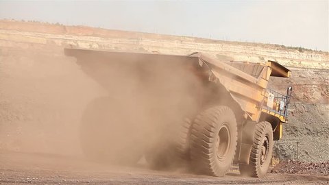 mining trucks in giant open pit mine, heavy mining truck loaded with iron ore on the opencast quarry, Haul truck in a iron mine