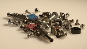 A desaturated view of various computer screws and other spare parts