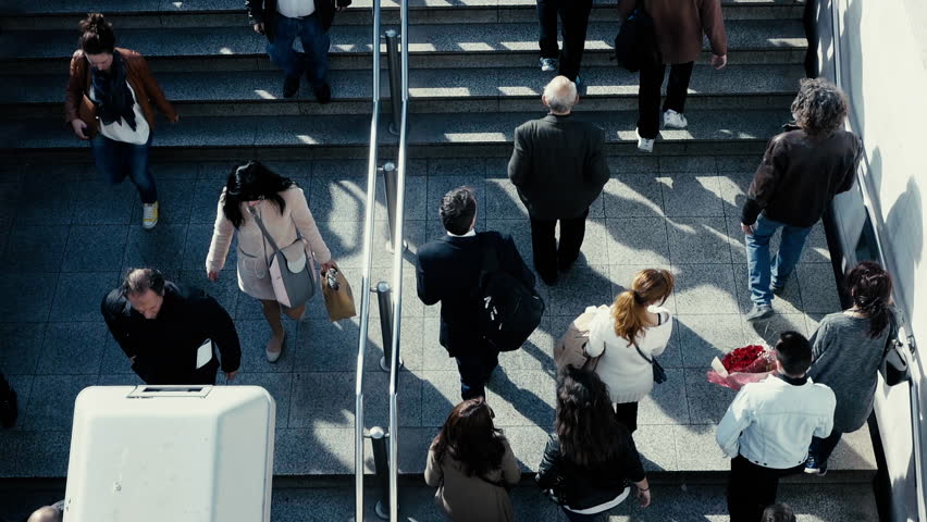 Birds eye view dolly slow motion people walk steps from/to underground entrance.100-25p super slomo dolly overhead tracking of people walking to the underground train station.No logos/faces visible. Royalty-Free Stock Footage #15081154