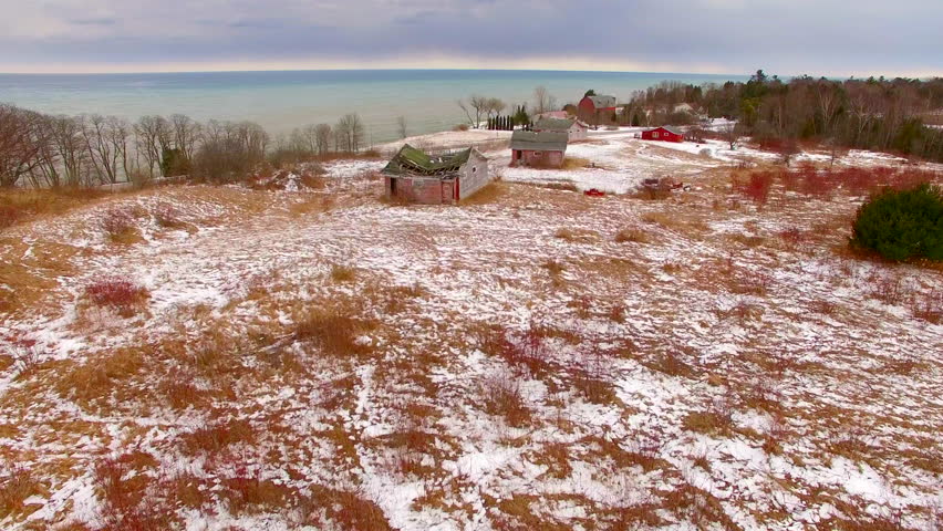 Abandoned cottages adorn a hilltop in Door County, Wisconsin.
 Scenic Door County Wisconsin, Rustic shoreline aerial flyover in Springtime as the last snows melt.