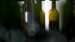 Wine bottle filling along a conveyor belt in a wine bottling factory