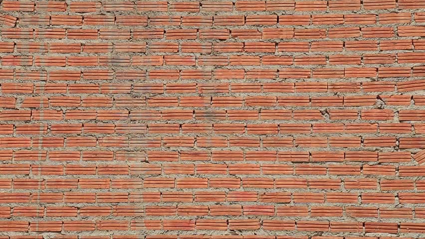 New built red brick wall, closeup view in upward motion