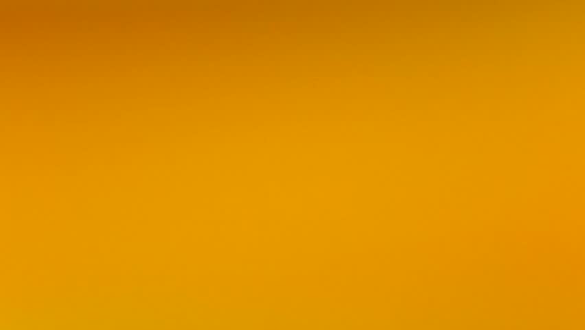 Cut ripe orange hits orange juice surface and rebounces. Slow motion video Royalty-Free Stock Footage #15091519