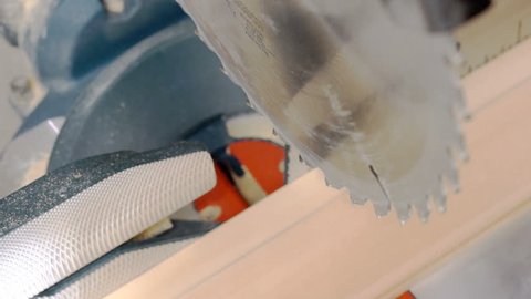 Cutting wooden plank with miter saw