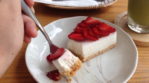 Eating strawberry cheesecake