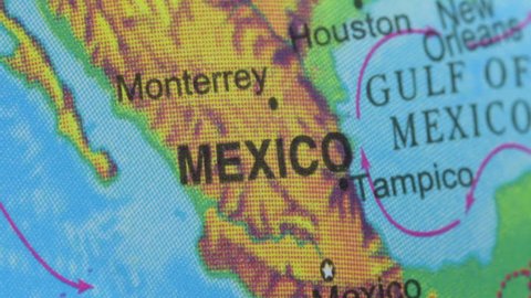 Terrestrial globe smoothly rotates and stops at the map of Mexico